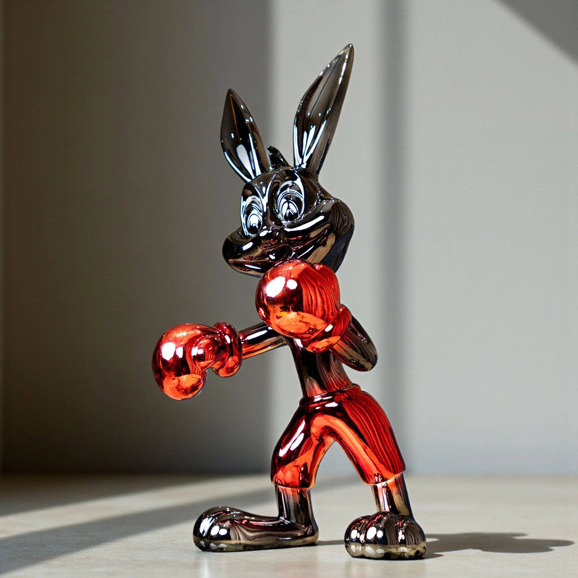 Resin bunny boxer figurine with chrome silver finish and crimson red gloves and shorts