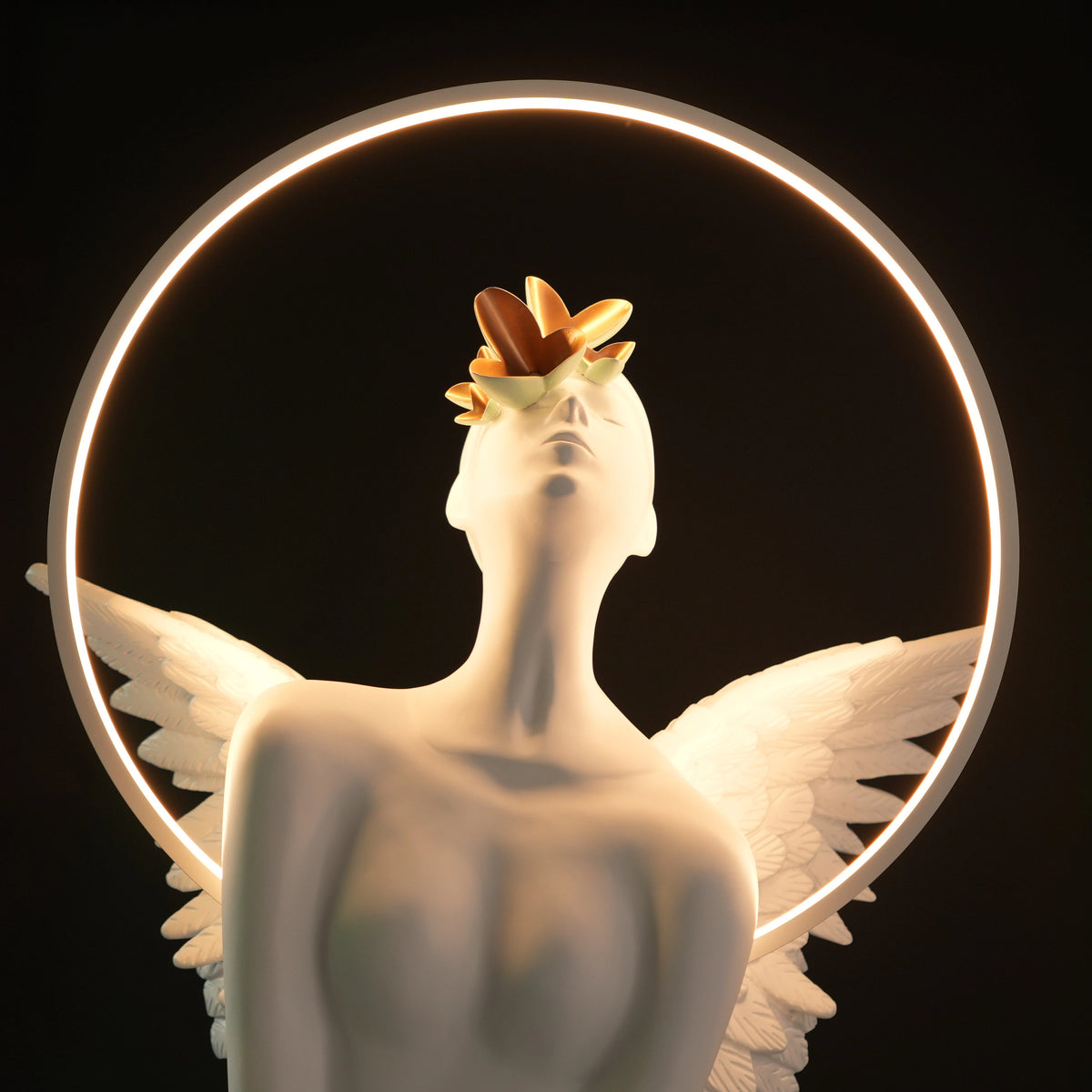 White angelic sculpture with wings, gold crown, and LED halo on marble-style base — Heavenly Wing Sculpture by Ghar Art, handcrafted luxury home decor accent symbolizing peace and divinity.