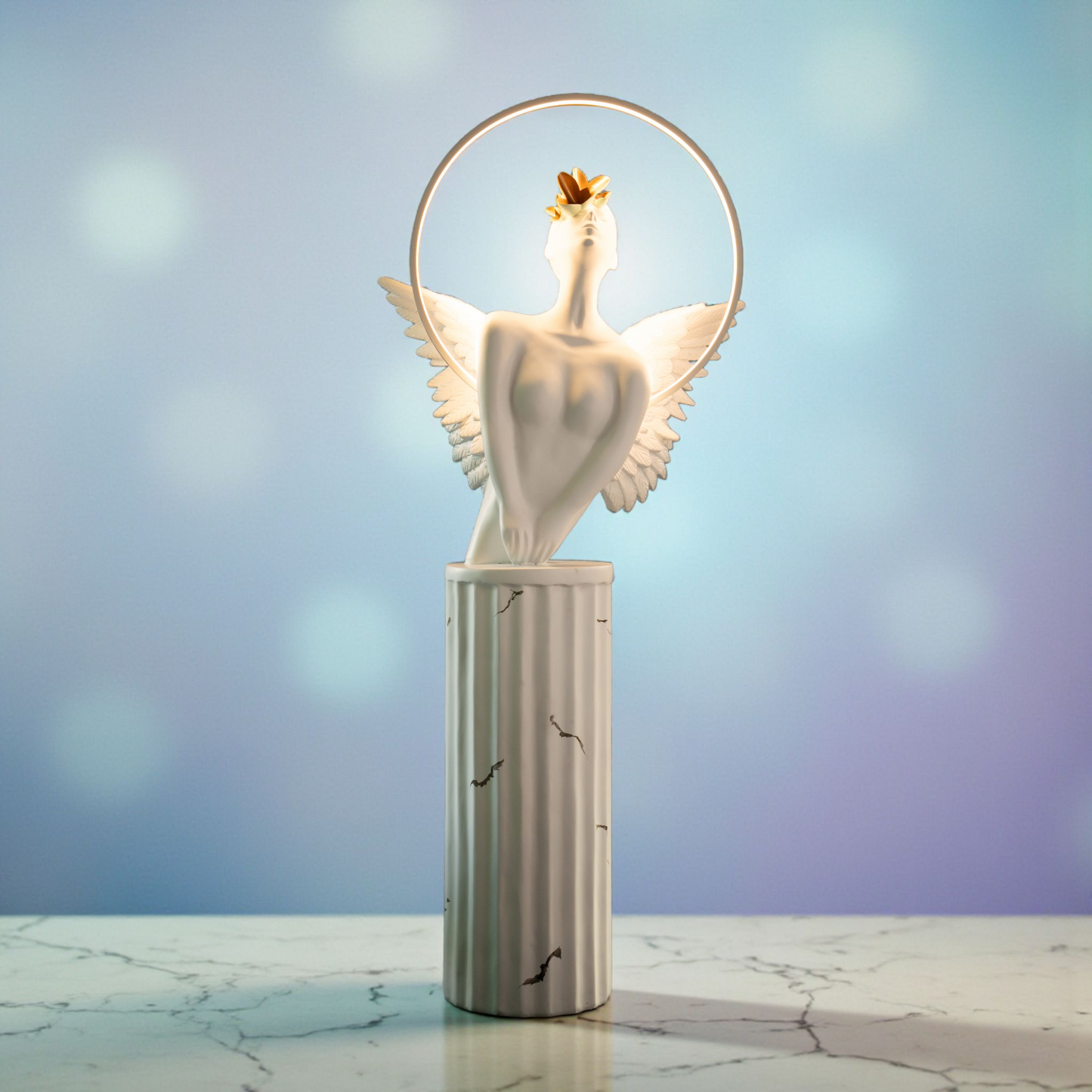 White angelic sculpture with wings, gold crown, and LED halo on marble-style base — Heavenly Wing Sculpture by Ghar Art, handcrafted luxury home decor accent symbolizing peace and divinity.