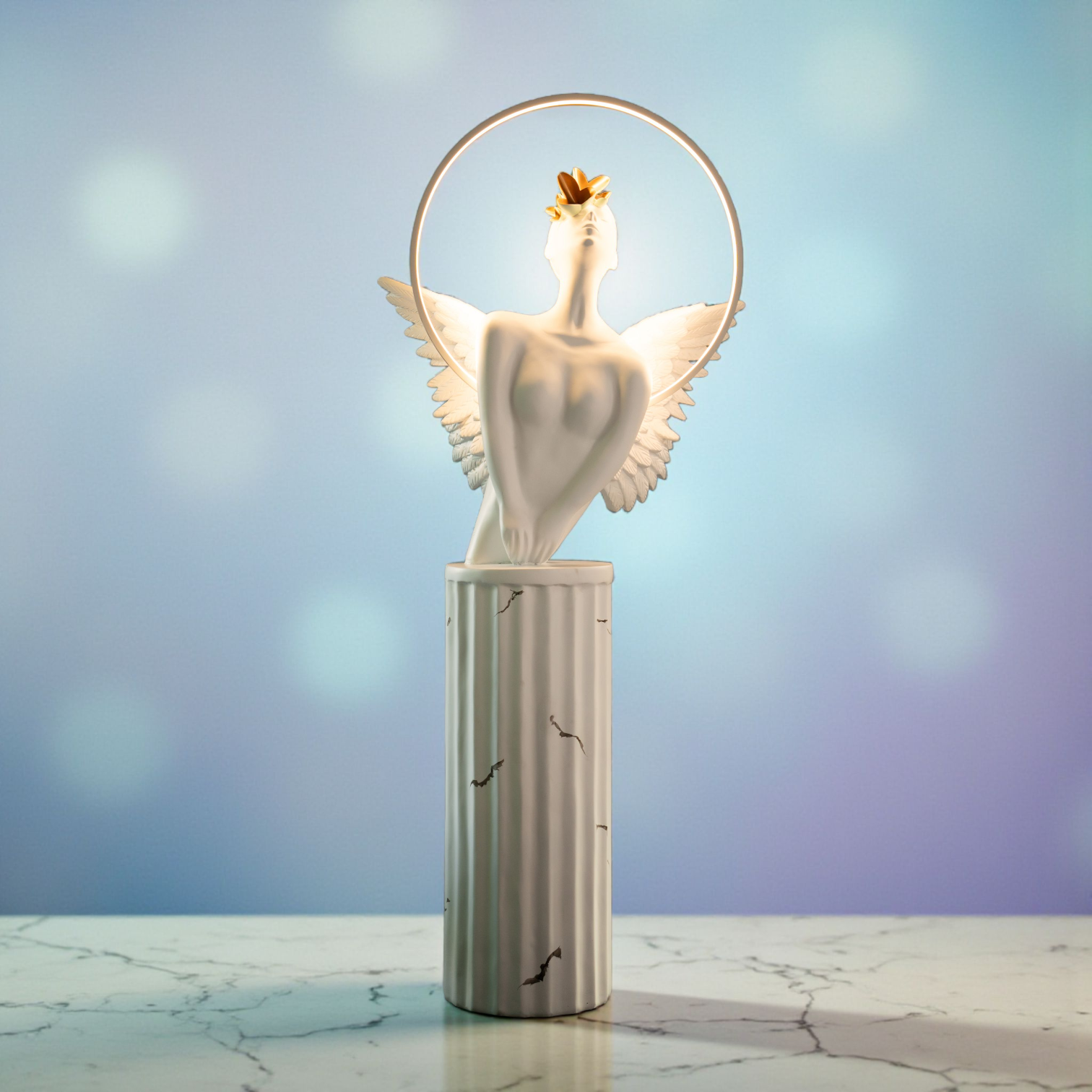 White angelic sculpture with wings, gold crown, and LED halo on marble-style base — Heavenly Wing Sculpture by Ghar Art, handcrafted luxury home decor accent symbolizing peace and divinity.