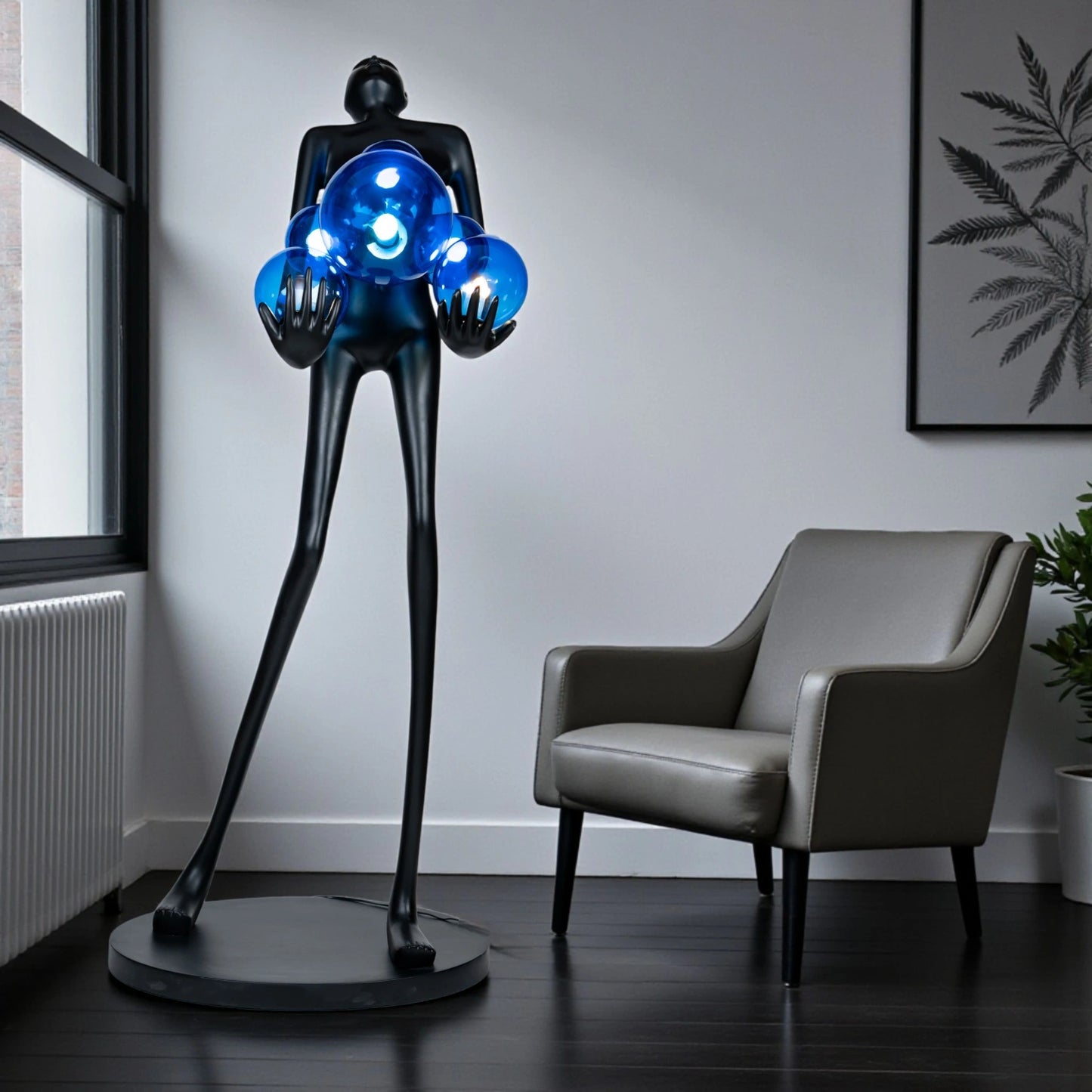 Tall matte black sculpture of human figure holding glowing blue light spheres — Azure Radiance Sculpture by Ghar Art, handcrafted illuminated modern home decor accent.