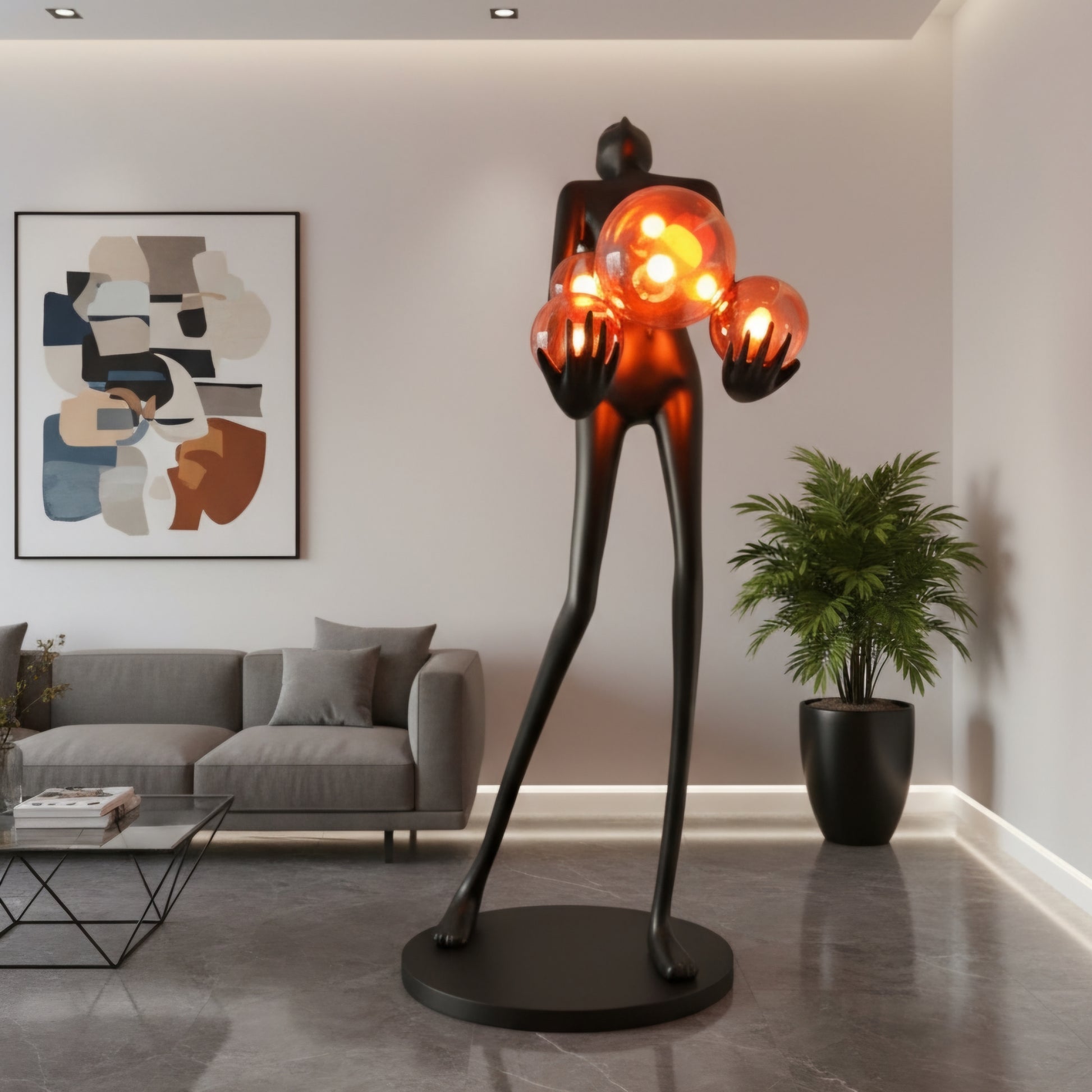 Tall matte black human figure sculpture holding glowing amber light spheres — Ember Radiance Sculpture by Ghar Art, illuminated modern luxury home decor accent.