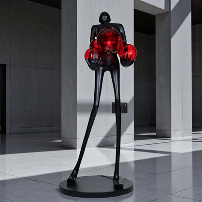 Tall matte black human figure sculpture holding glowing amber light spheres — Ember Radiance Sculpture by Ghar Art, illuminated modern luxury home decor accent.