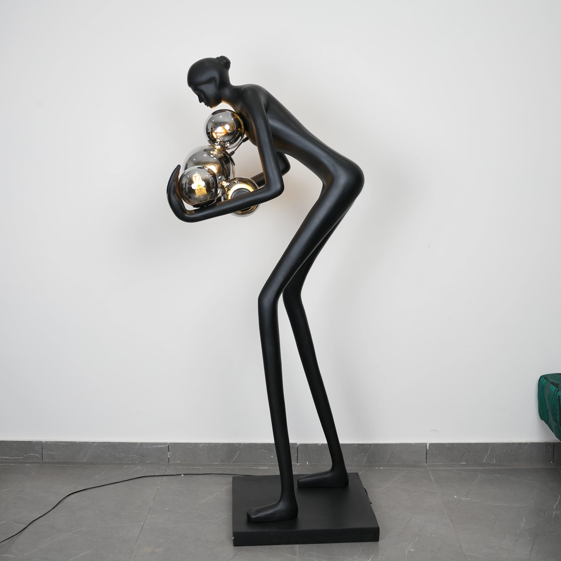 Glow figure lamp, chrome orbs, profile view
