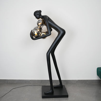Glow figure lamp, chrome orbs, profile view