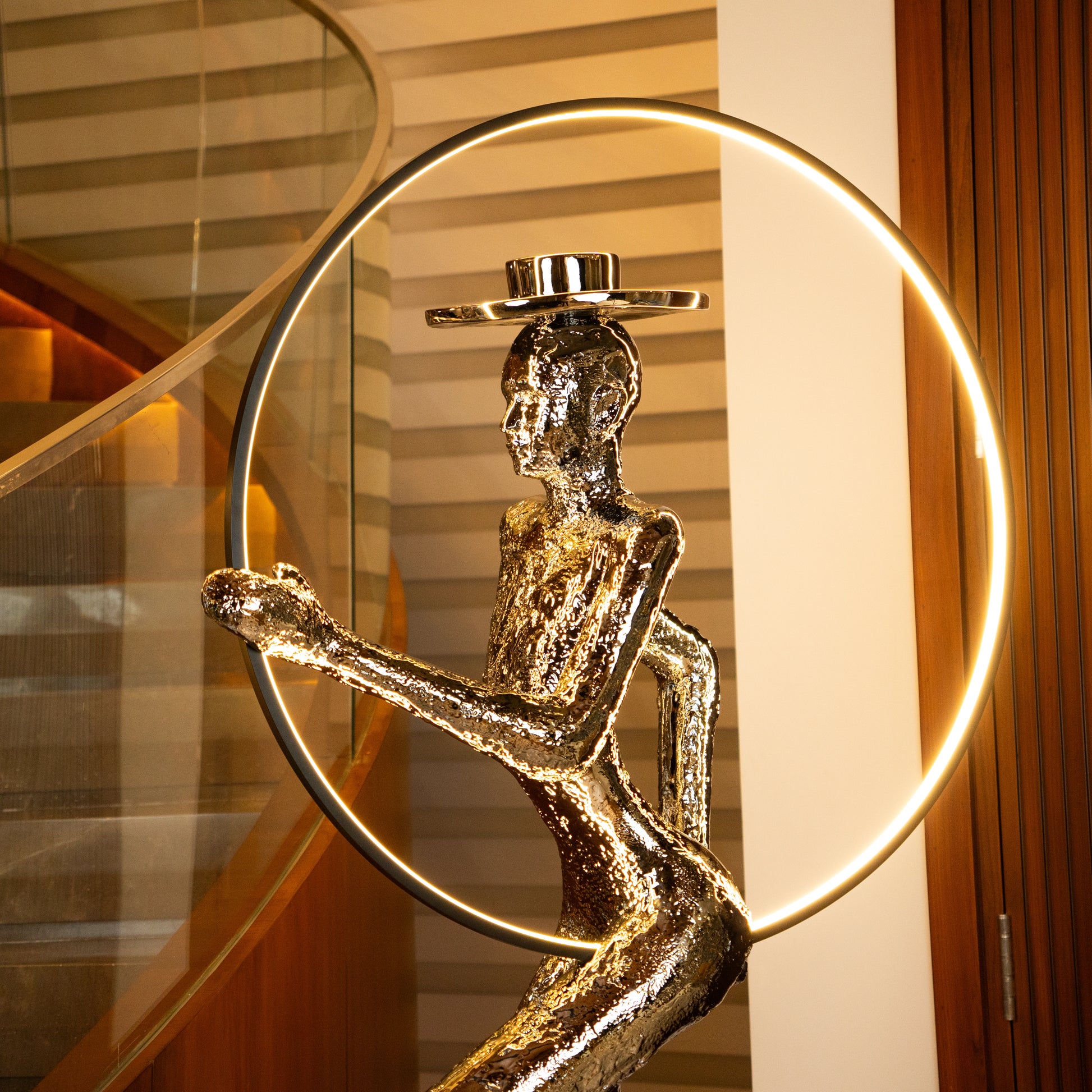 Silver electroplated human sculpture with glowing LED halo — Auric Poise Sculpture by Ghar Art, handcrafted metallic luxury home decor accent symbolizing balance and radiance.