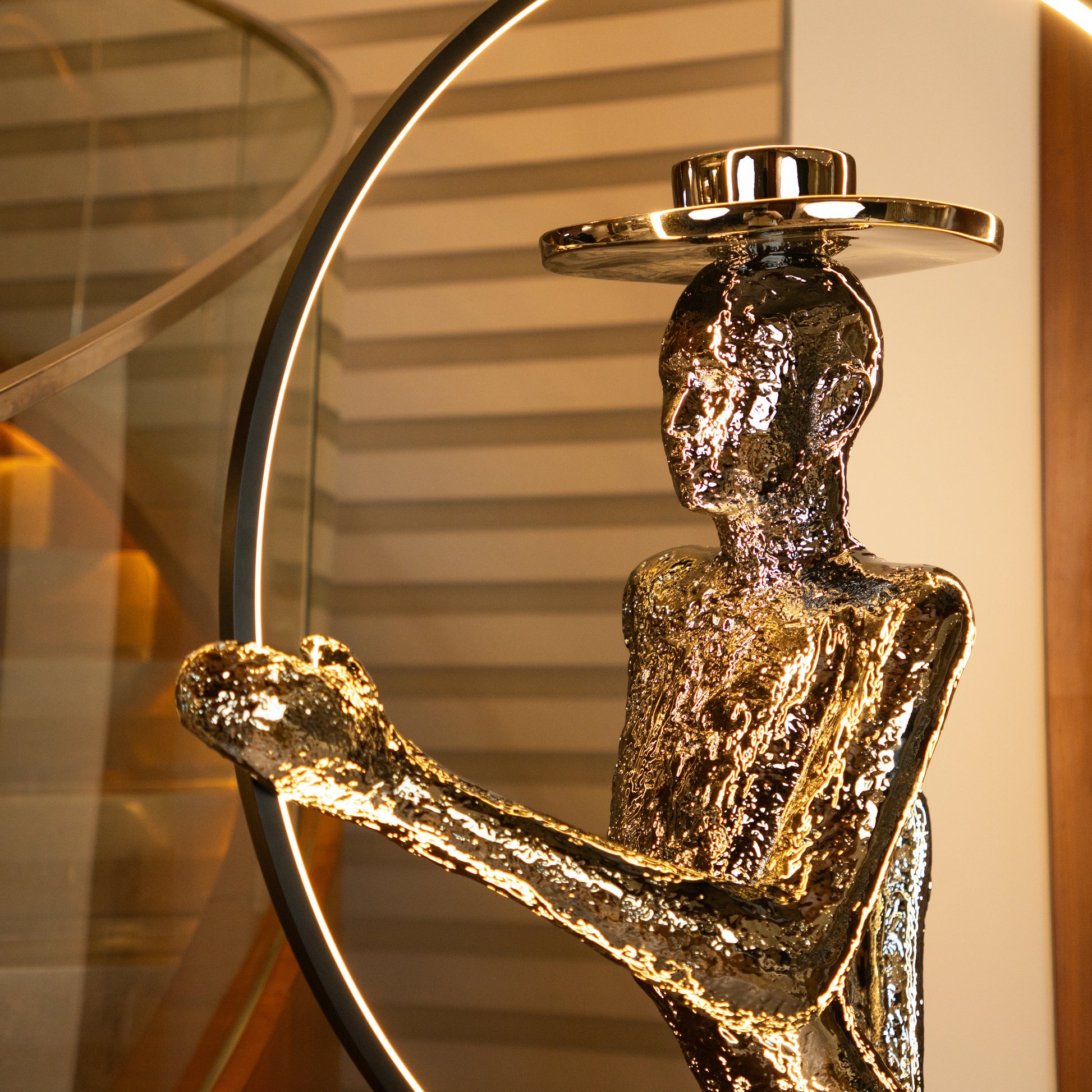 Silver electroplated human sculpture with glowing LED halo — Auric Poise Sculpture by Ghar Art, handcrafted metallic luxury home decor accent symbolizing balance and radiance.