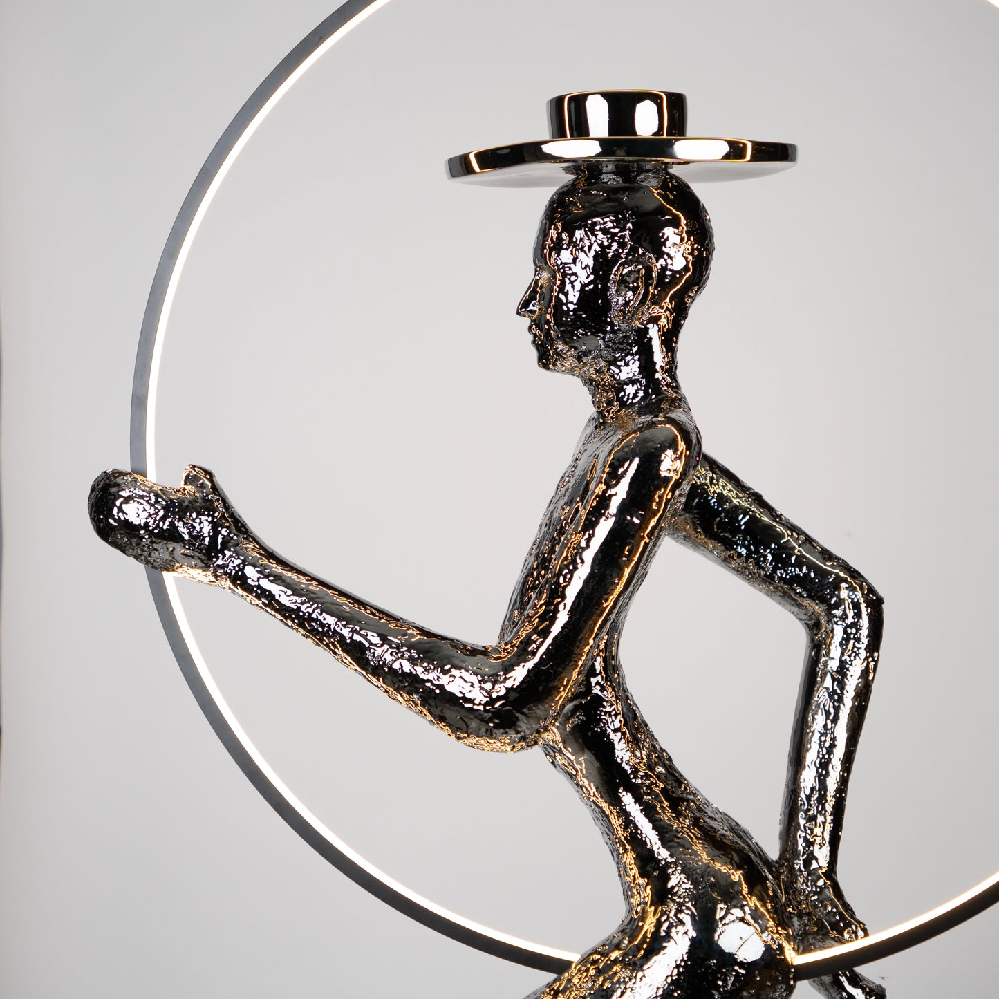 Silver electroplated human sculpture with glowing LED halo — Auric Poise Sculpture by Ghar Art, handcrafted metallic luxury home decor accent symbolizing balance and radiance.