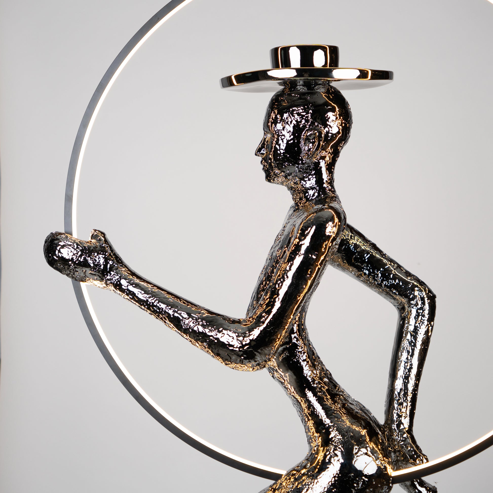 Silver electroplated human sculpture with glowing LED halo — Auric Poise Sculpture by Ghar Art, handcrafted metallic luxury home decor accent symbolizing balance and radiance.