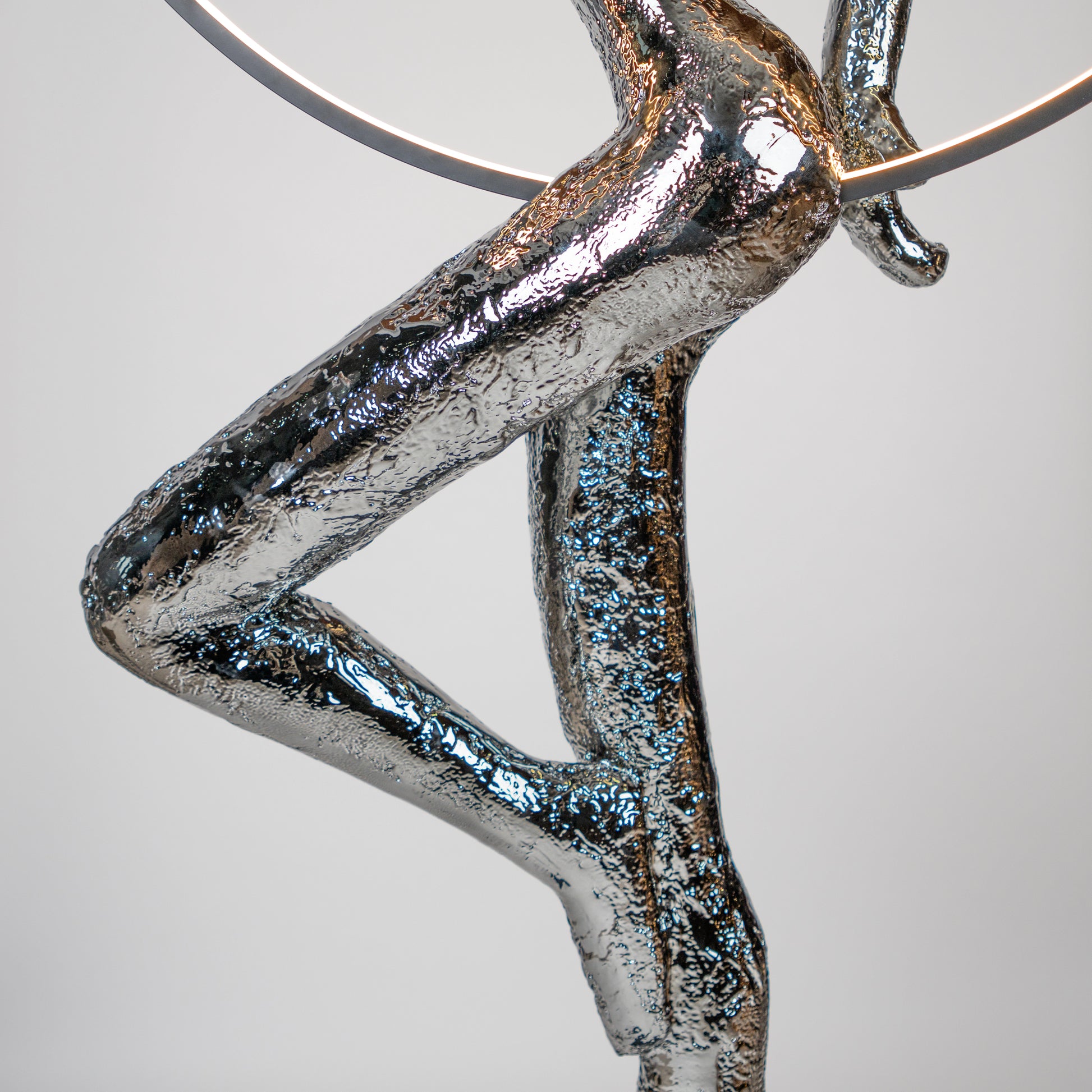 Silver electroplated human sculpture with glowing LED halo — Auric Poise Sculpture by Ghar Art, handcrafted metallic luxury home decor accent symbolizing balance and radiance.