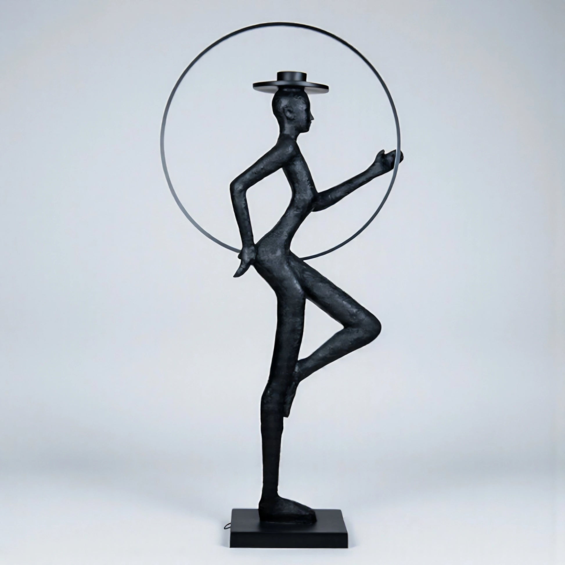Tall black resin luminous poise sculpture with glowing LED halo — The Illuminated Voyager Sculpture by Ghar Art, handcrafted luxury home decor, 190 cm tall statement art piece.