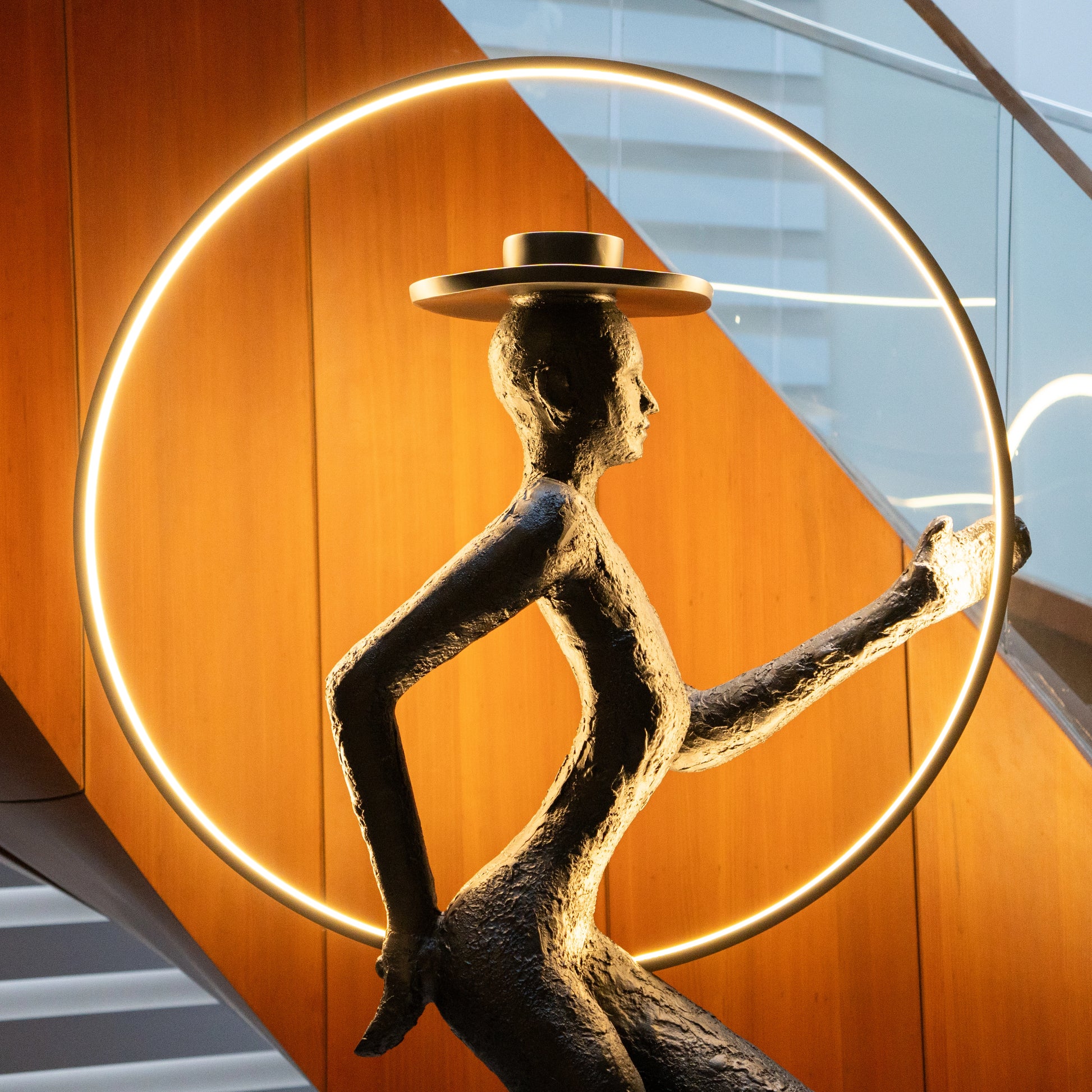 Tall black resin luminous poise sculpture with glowing LED halo — The Illuminated Voyager Sculpture by Ghar Art, handcrafted luxury home decor, 190 cm tall statement art piece.