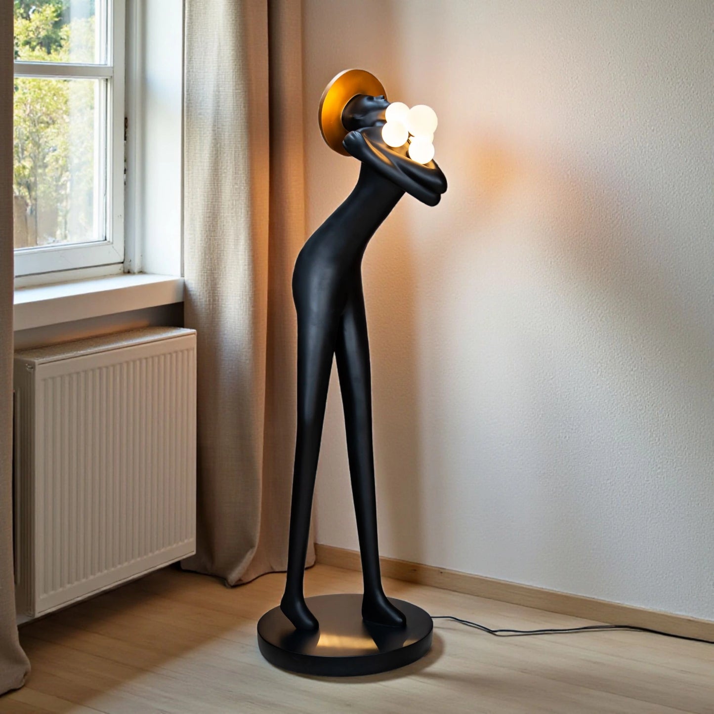 Tall black human-form floor sculpture holding glowing light orbs