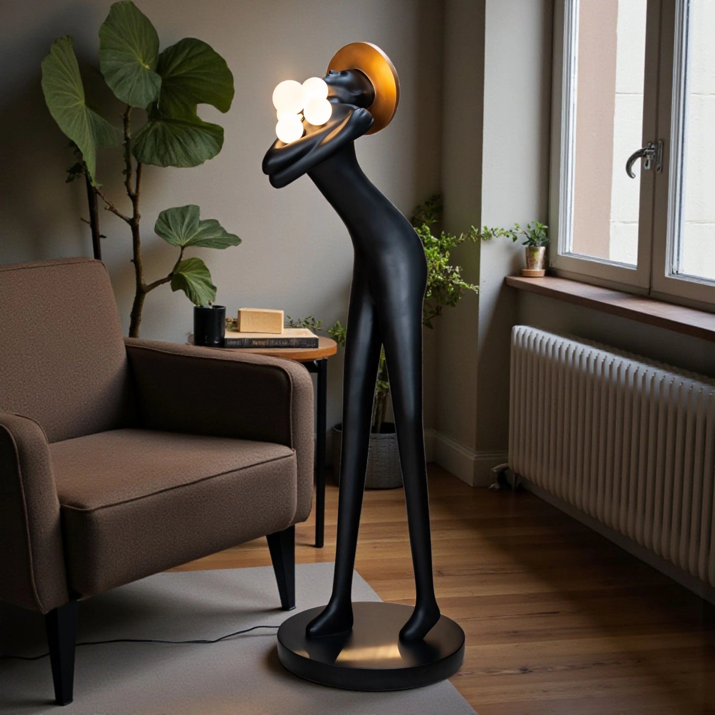 Tall black human-form floor sculpture holding glowing light orbs