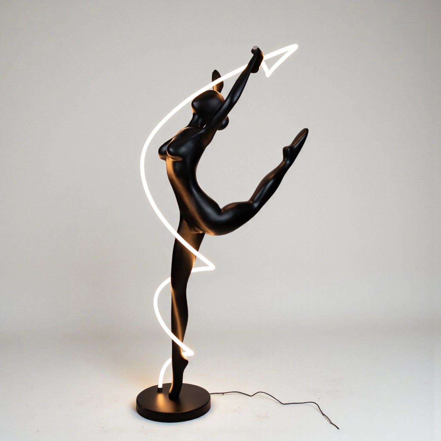 Matte black human figure sculpture with glowing spiral LED light