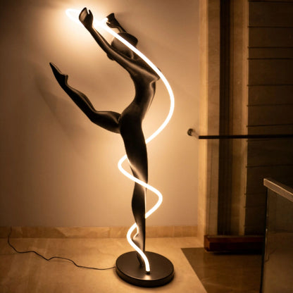 Matte black human figure sculpture with glowing spiral LED light