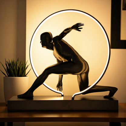 Matte black illuminated human motion sculpture with halo light ring on rectangular base