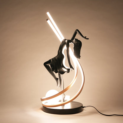 Decorative lamp with a figure on a crescent moon against a beige background
