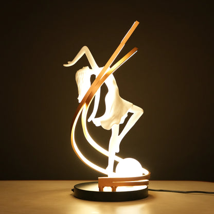 Small white sculpture lamp of a dancing woman with sweeping LED arcs and a glowing orb on a black base.