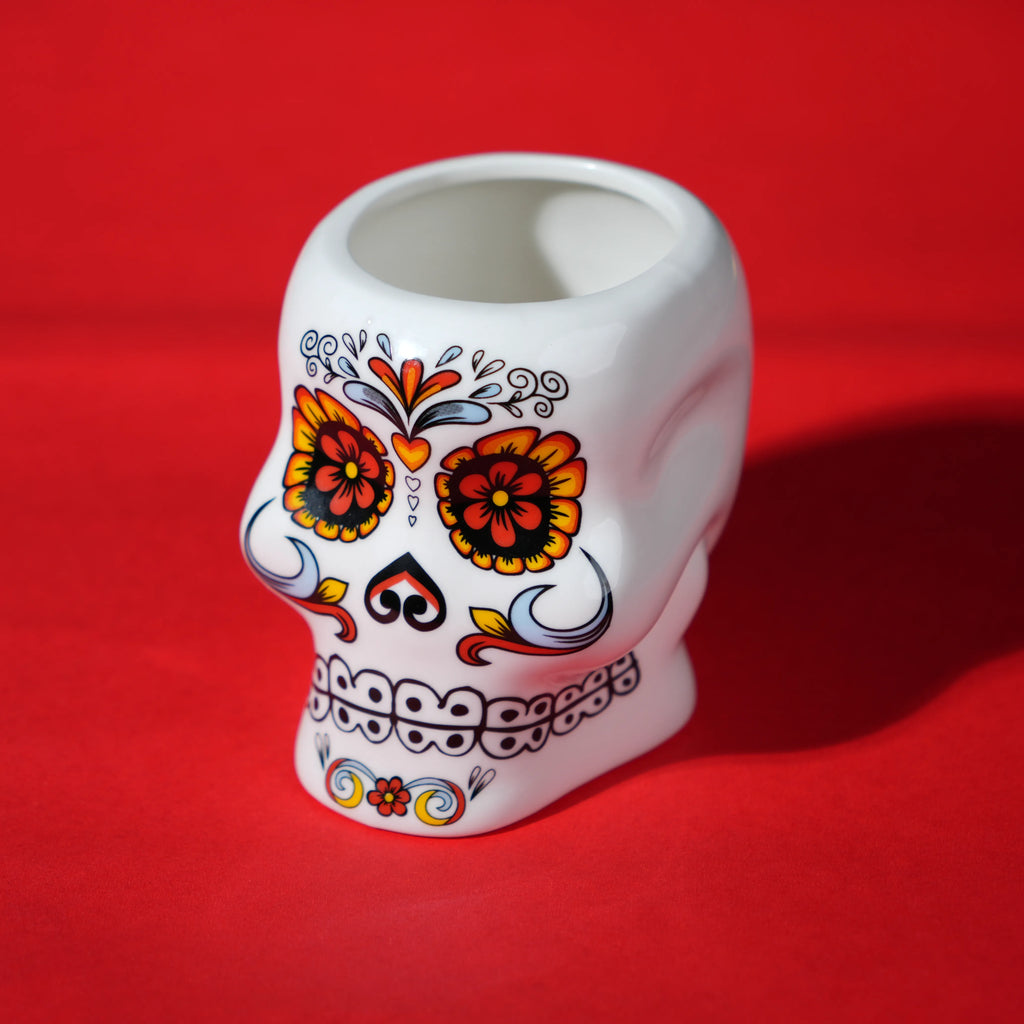 white ceramic skull glass with multicolor viking-style artwork