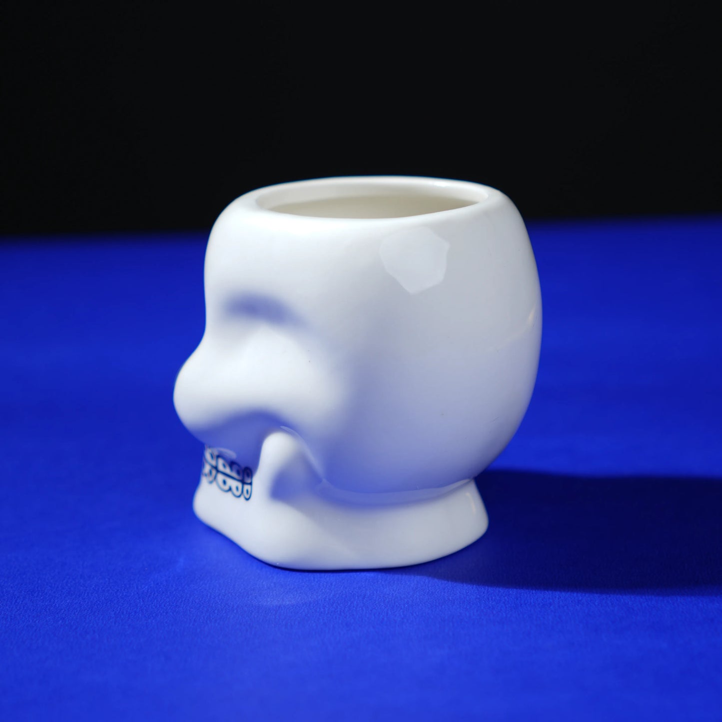 white ceramic skull glass with multicolor viking-style artwork