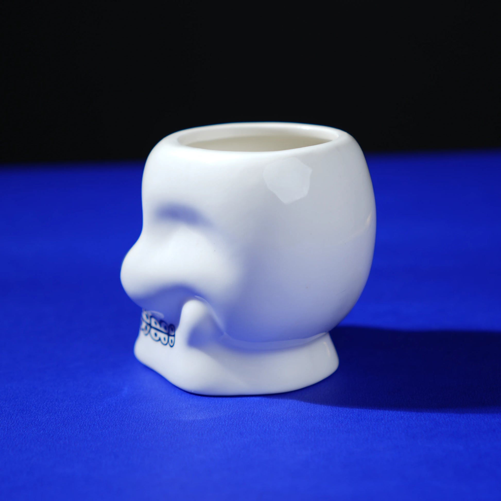 white ceramic skull glass with multicolor viking-style artwork