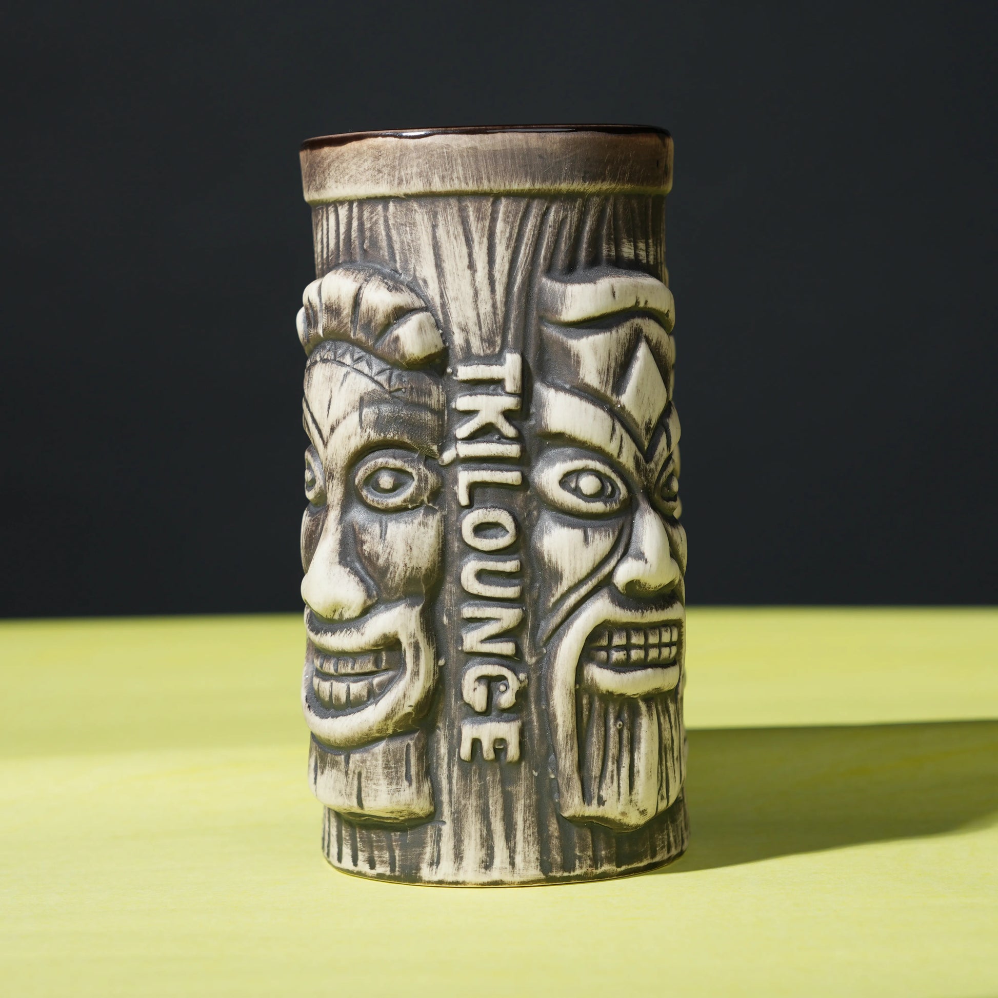 ceramic tribal tiki mug with carved faces