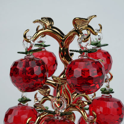 Dense cluster golden crystal apple tree with multiple red faceted apples on a mirrored base.