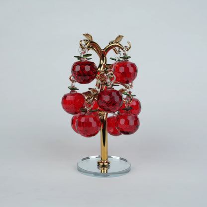 Dense cluster golden crystal apple tree with multiple red faceted apples on a mirrored base.