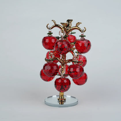 Dense cluster golden crystal apple tree with multiple red faceted apples on a mirrored base.