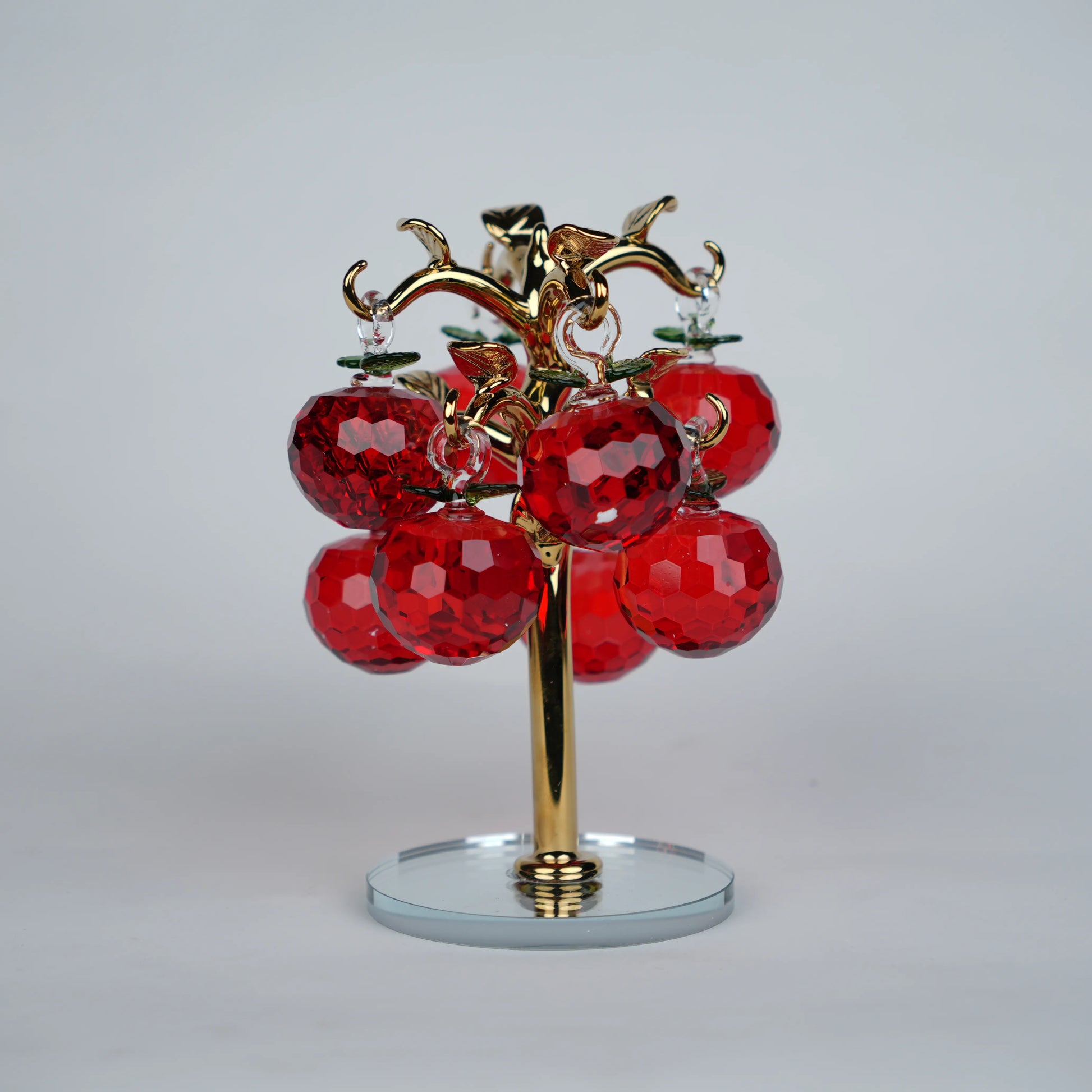 Large golden crystal apple tree décor with red faceted crystal apples on a mirrored base
