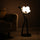 Modern artistic standing floor lamp featuring abstract human silhouette and ambient orb lighting accents