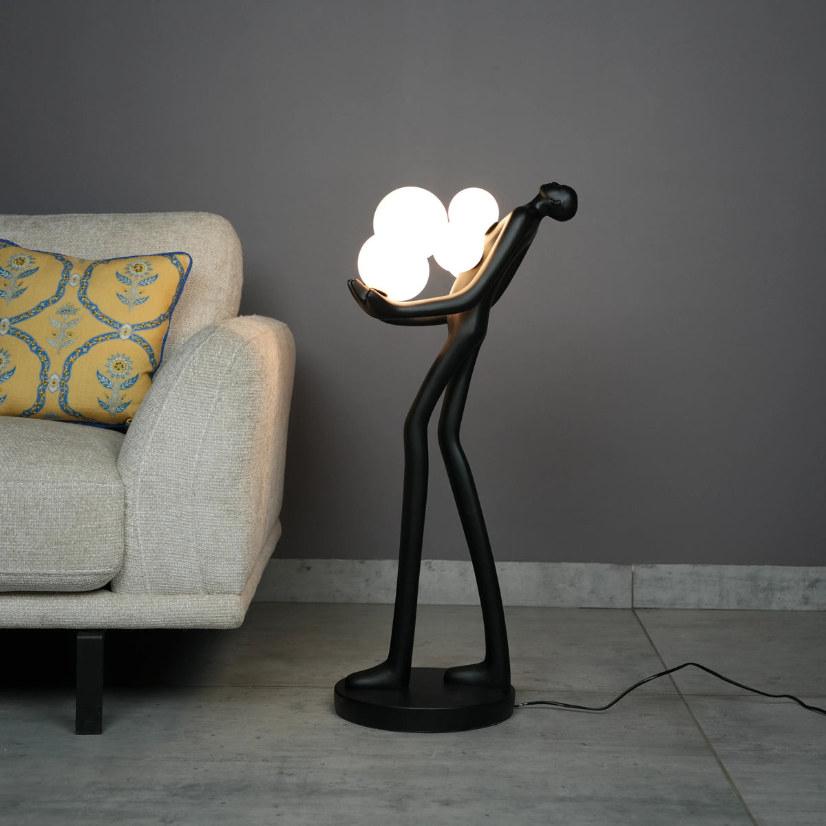 Modern artistic standing floor lamp featuring abstract human silhouette and ambient orb lighting accents