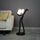 Modern artistic standing floor lamp featuring abstract human silhouette and ambient orb lighting accents