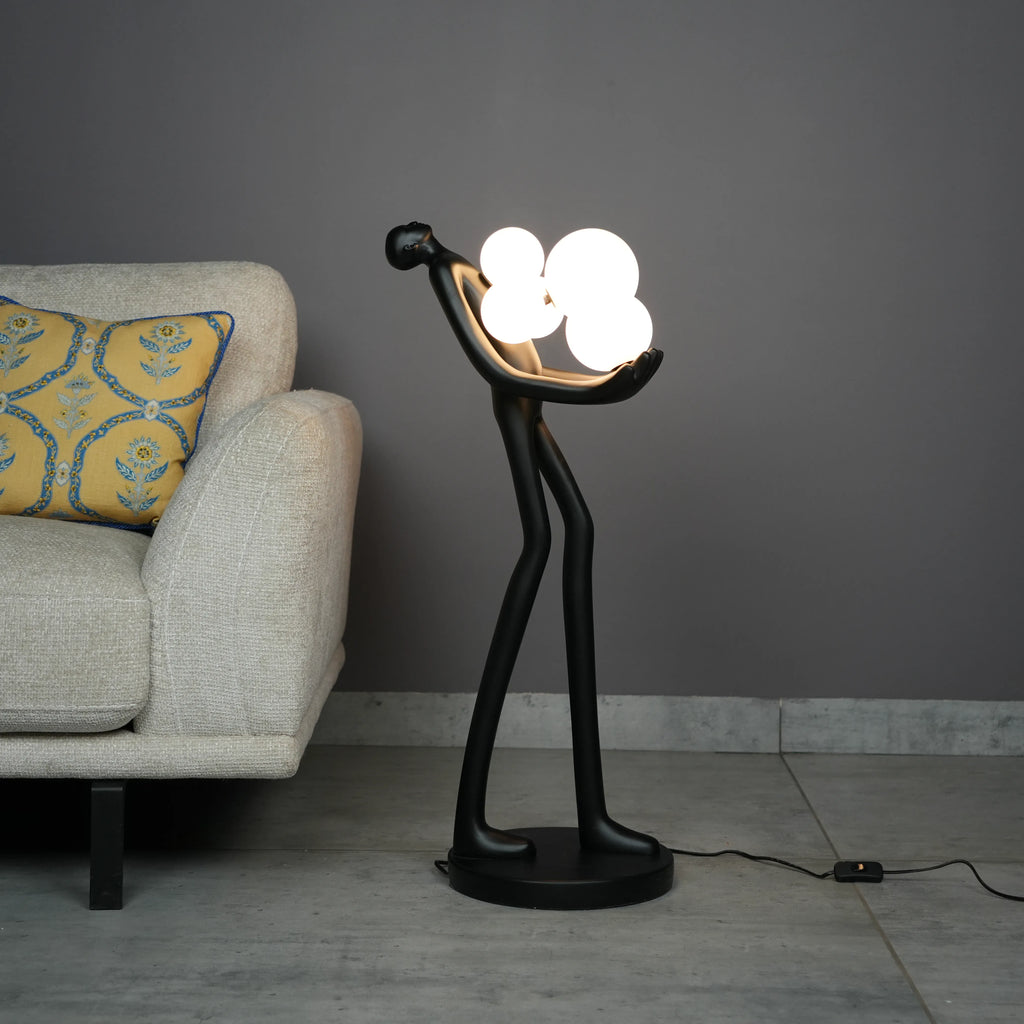 Modern artistic standing floor lamp featuring abstract human silhouette and ambient orb lighting accents