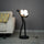 Modern artistic standing floor lamp featuring abstract human silhouette and ambient orb lighting accents