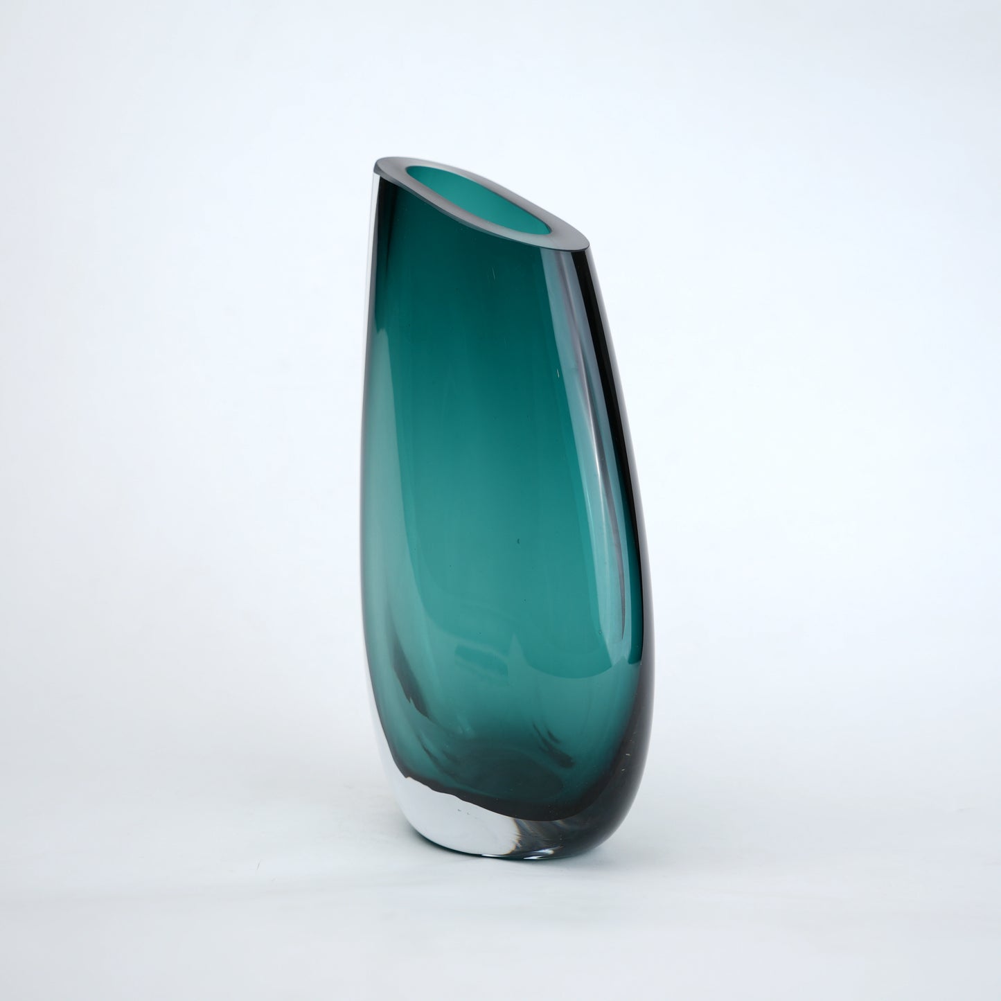 Deep teal curved glass vase with angled opening modern decor
