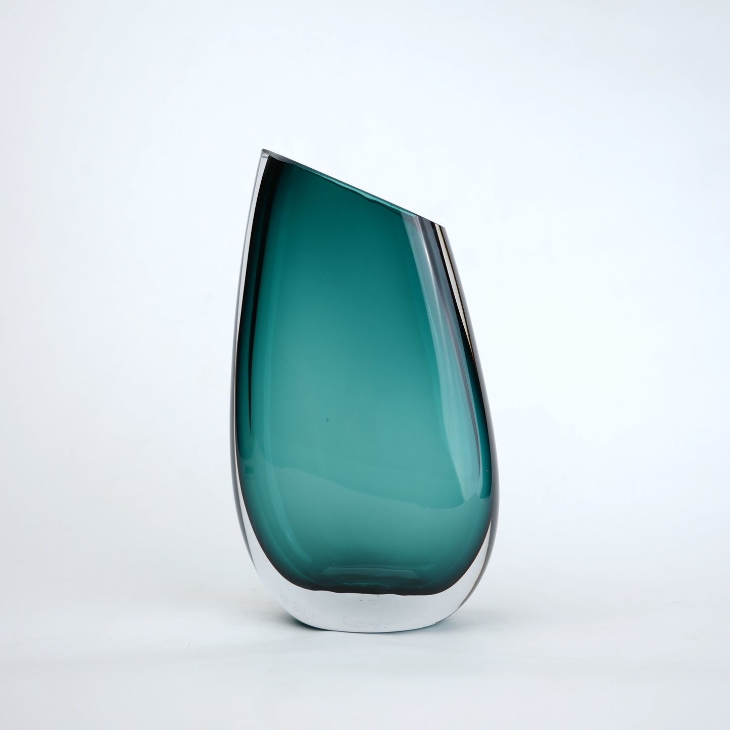 Deep teal curved glass vase with angled opening modern decor