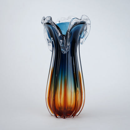 Glass vase with blue and orange gradient on a white background