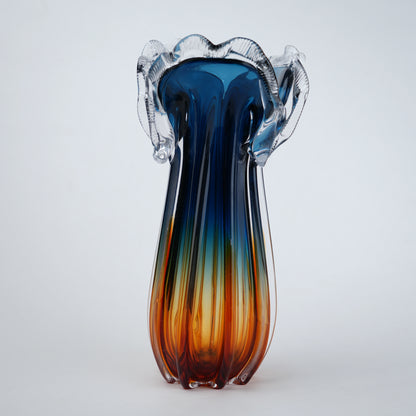 Glass vase with blue and orange gradient on a white background