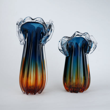 Two colorful glass vases with a gradient of blue, green, and orange on a white background.