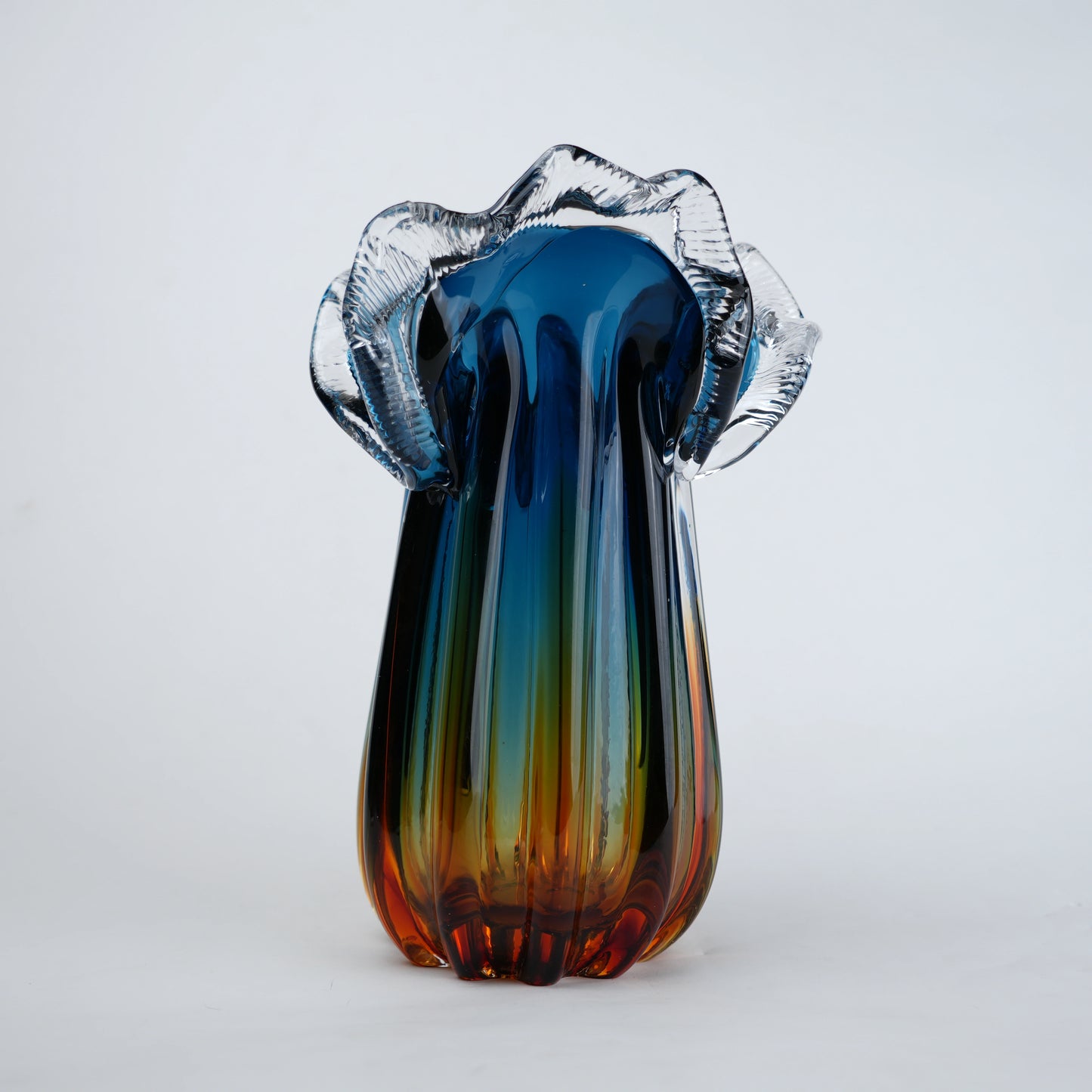 Blue gradient glass vase with multicolor base and clear flared rim