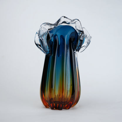 Blue gradient glass vase with multicolor base and clear flared rim