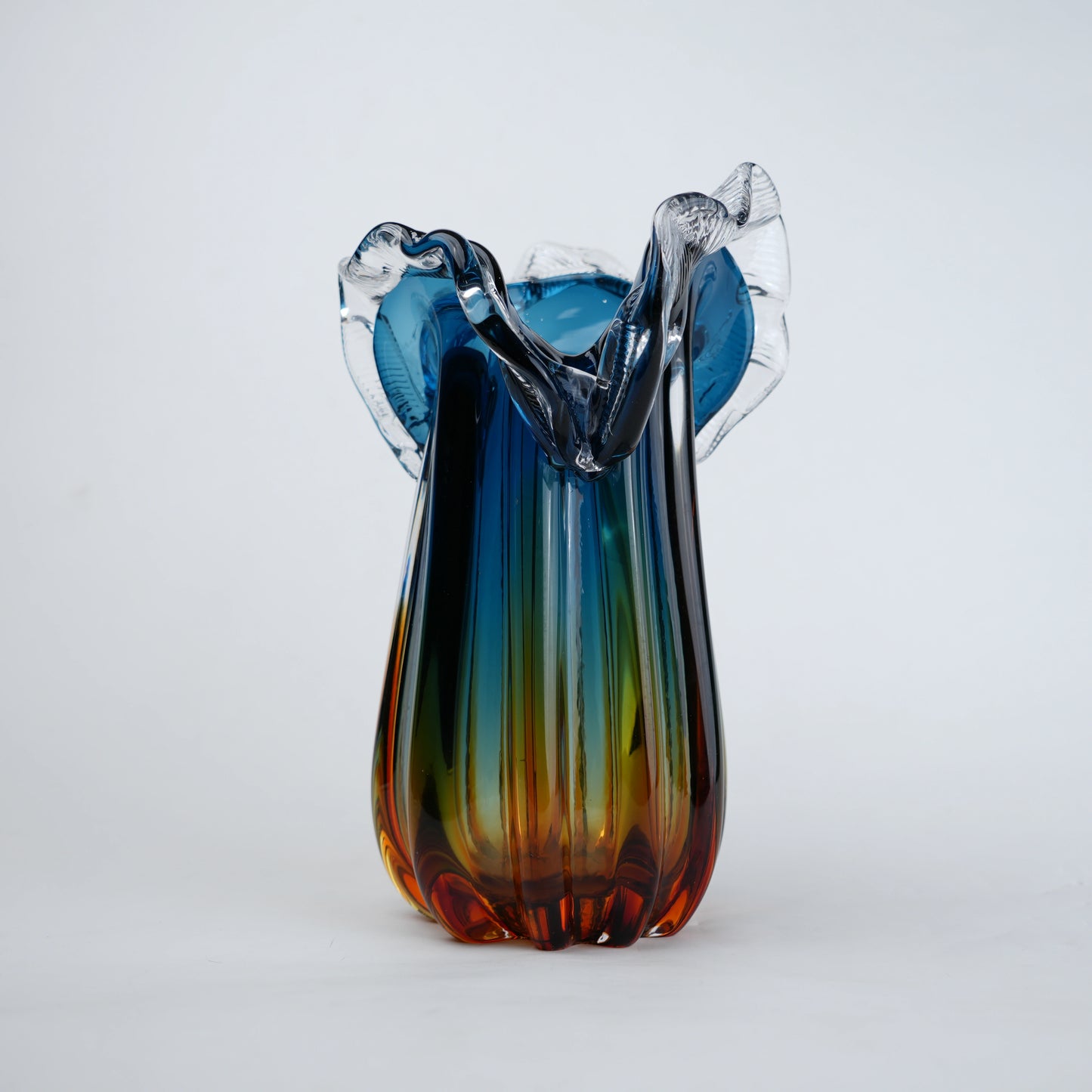Blue gradient glass vase with multicolor base and clear flared rim