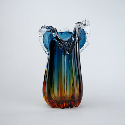 Blue gradient glass vase with multicolor base and clear flared rim