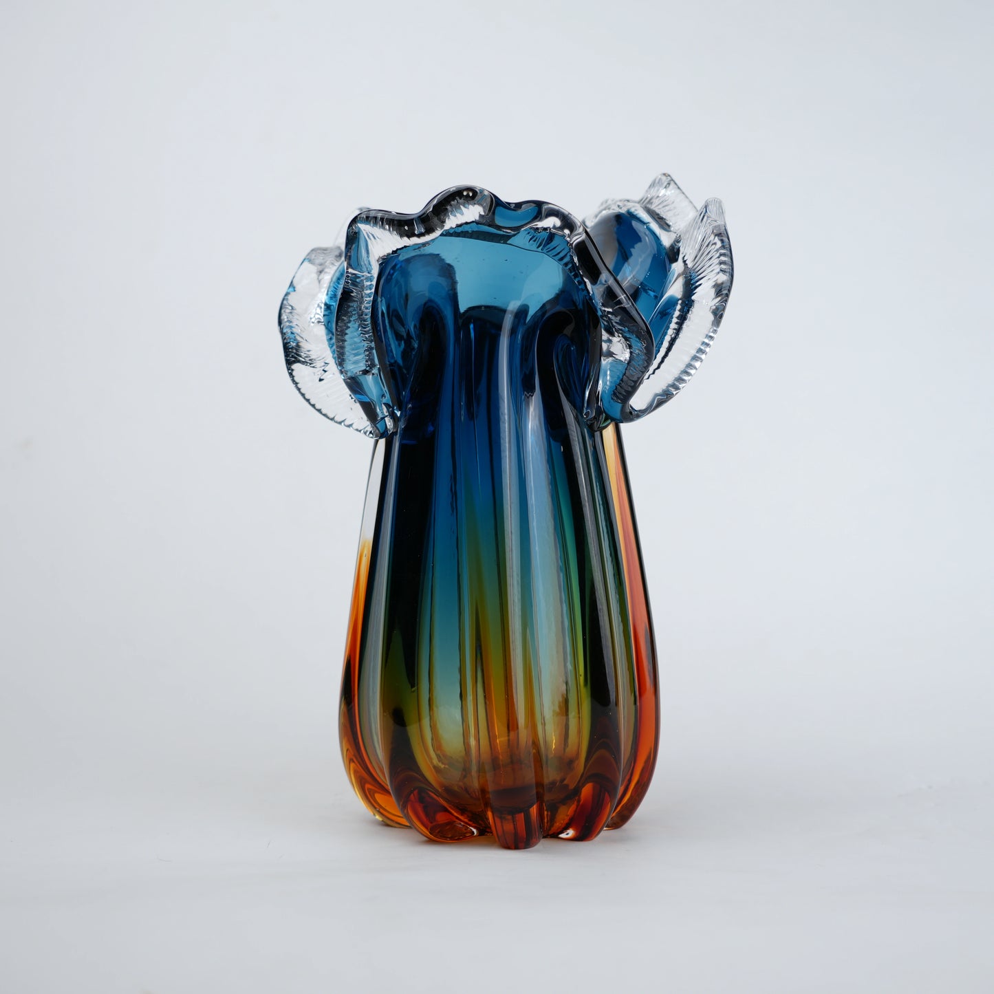 Blue gradient glass vase with multicolor base and clear flared rim
