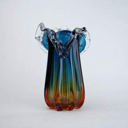 Blue gradient glass vase with multicolor base and clear flared rim