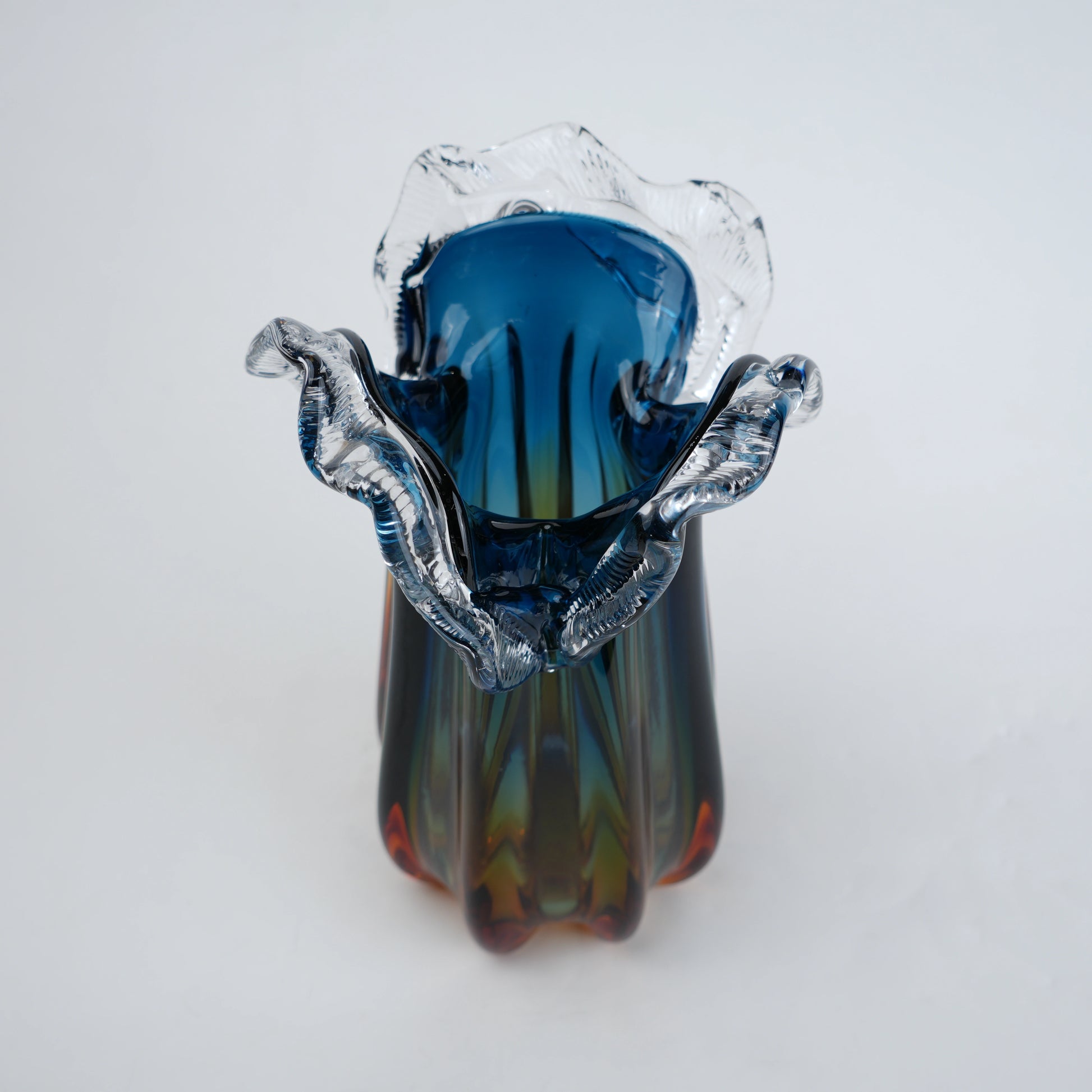 Blue gradient glass vase with multicolor base and clear flared rim