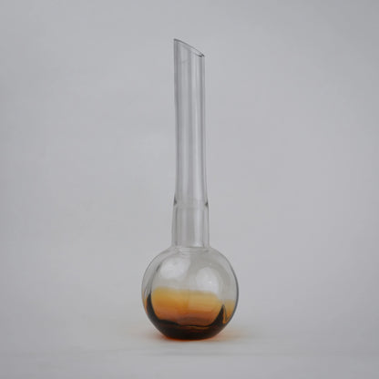 Glass vase with spherical base and elongated cylindrical neck designed for single stem floral arrangements