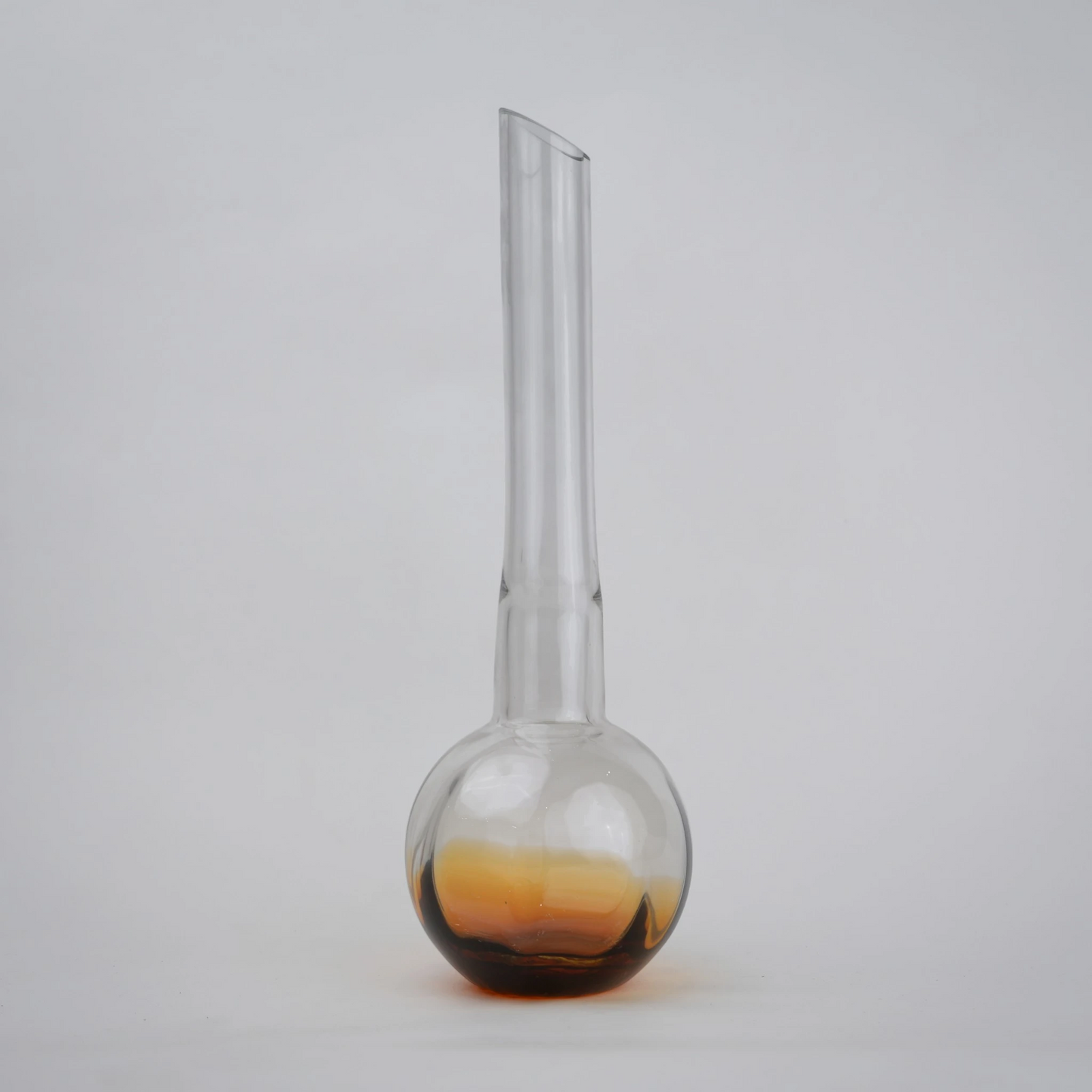 Glass vase with spherical base and elongated cylindrical neck designed for single stem floral arrangements